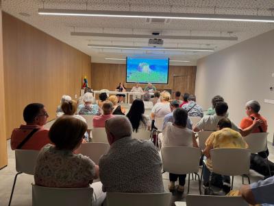 La imagen muestra a los participantes en la asamblea.