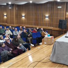 Imagen del salón de actos y de los asistentes a la asamblea.